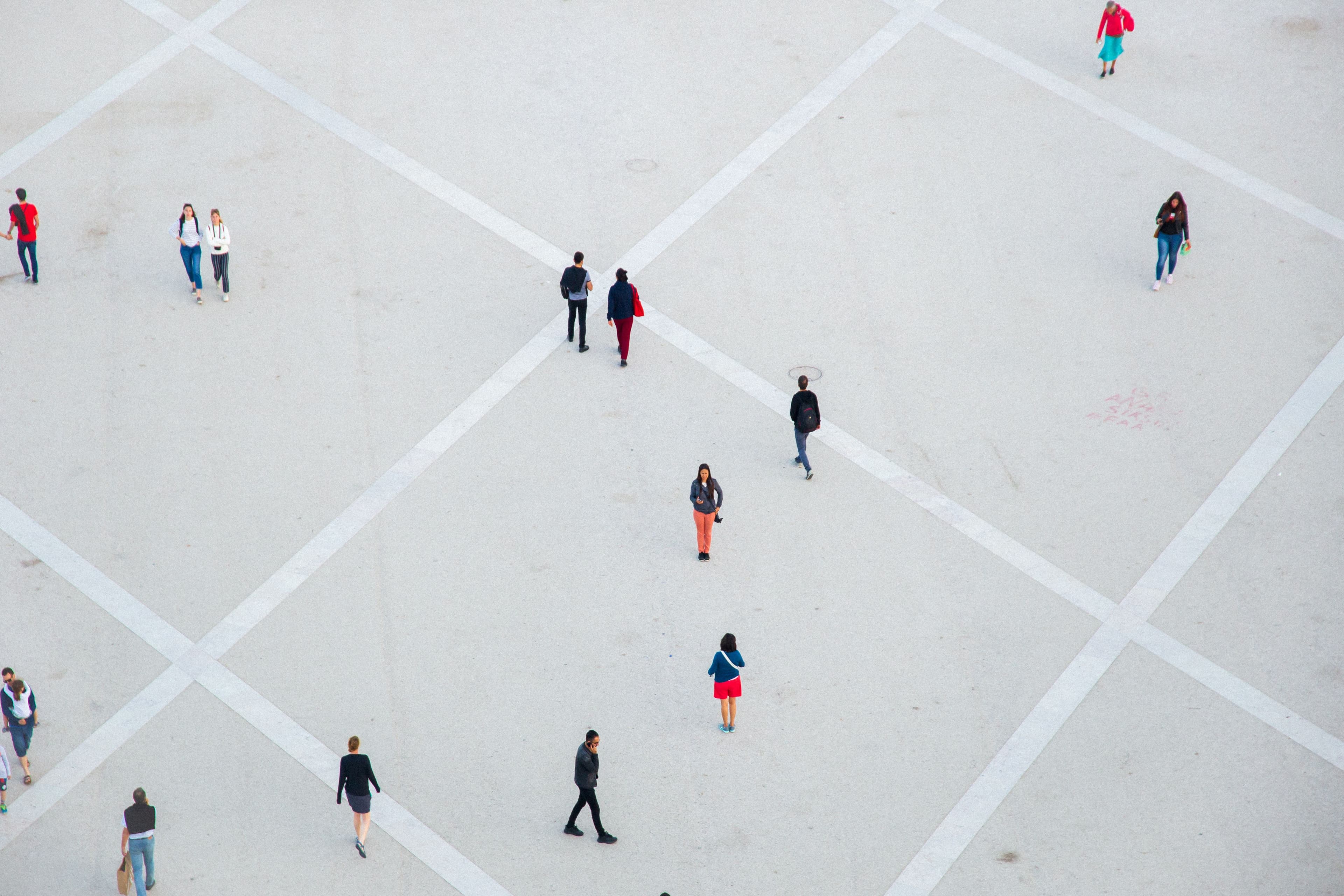 People walking across a plaza